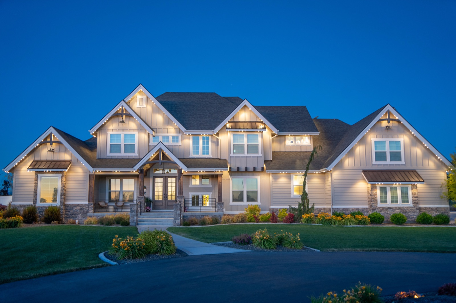 Residential home with warm-white permanent accent lighting along the roofline at dusk