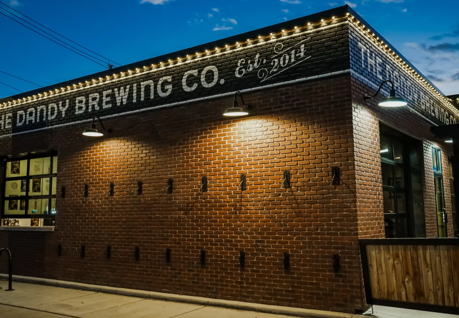 The Dandy Brewing Co. brick building with warm white roofline lighting